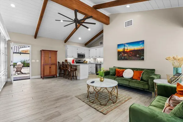 a kitchen with granite countertop white cabinets and a stove top oven