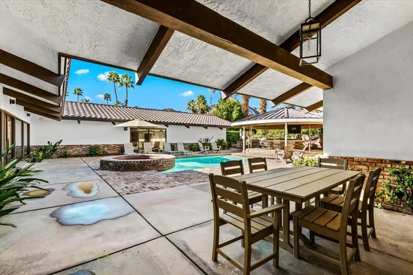 a view of a house with backyard porch and outdoor seating
