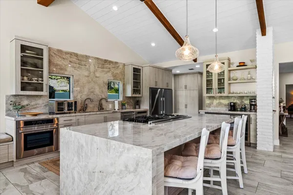 a kitchen with a stove and white cabinets