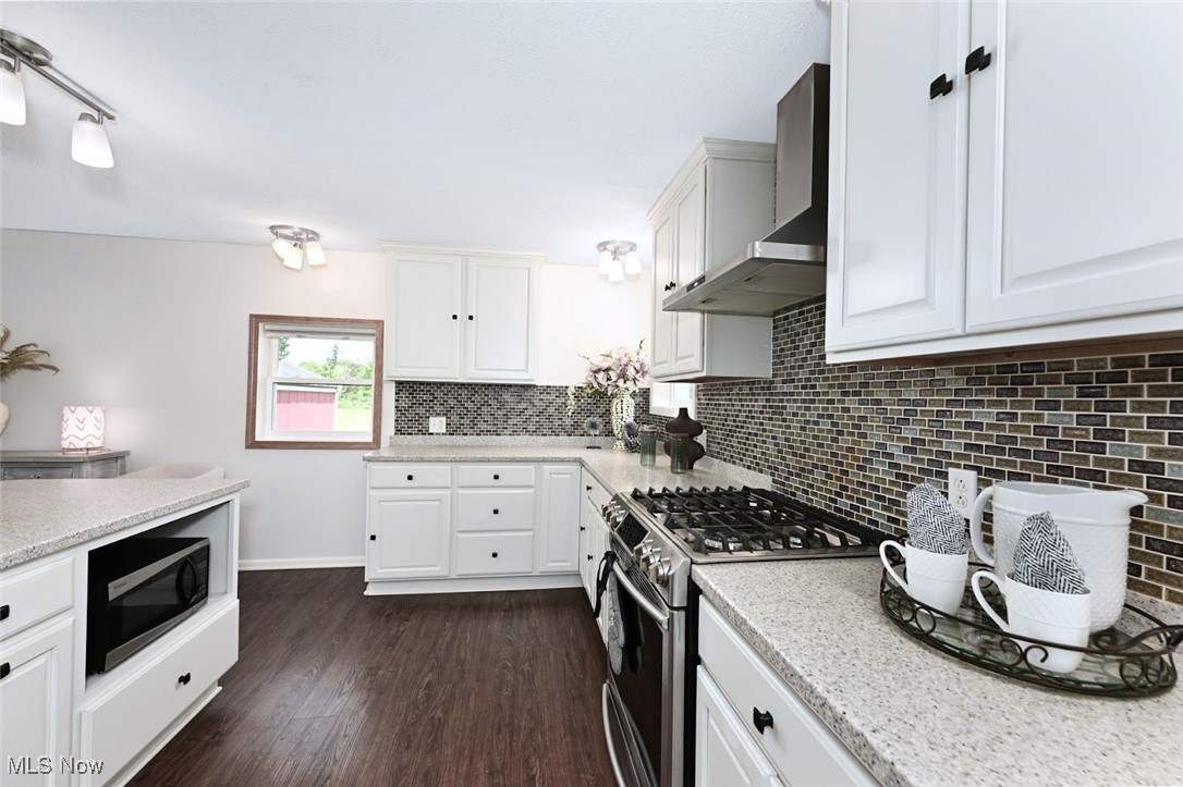 4597 Rock Cut Road Barberton, OH 44203 - Photo 17 of 44 *COMPLETELY REMODELED, EXTENDED KITCHEN W/WHITE CABINETS, SOFT CLOSE DRAWERS, PULL OUT DRAWERS, PANTRY, ISLAND WITH BREAKFAST BAR, MOSAIC TILE BACKSPLASH, TONS OF LIGHTING, STAINLESS STEEL APPLIANCES ~