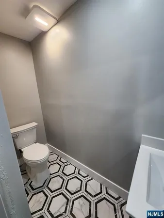 a bathroom with a sink toilet and mirror