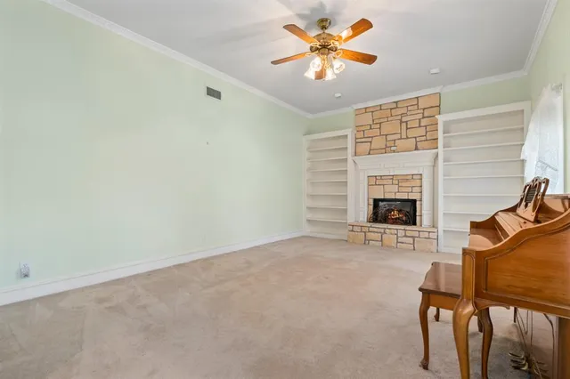 an empty room with furniture and fireplace
