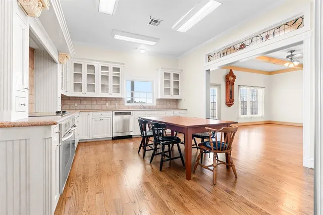 a large kitchen with a table and chairs in it