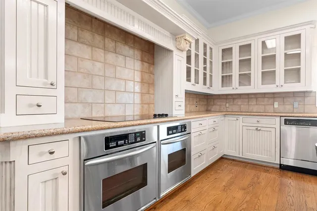 a kitchen with stainless steel appliances granite countertop a stove and a sink