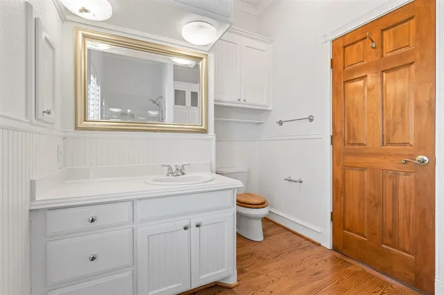 a bathroom with a toilet a sink and mirror