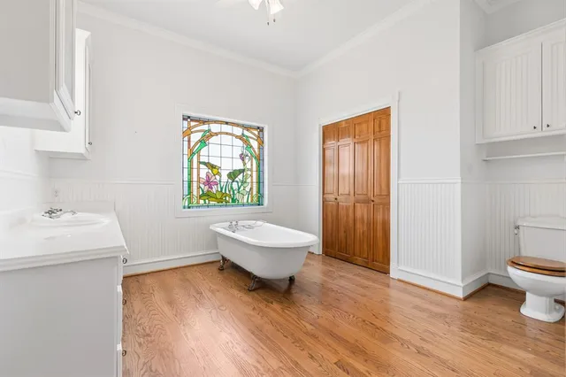 a living room with a sink and a window with wooden floor