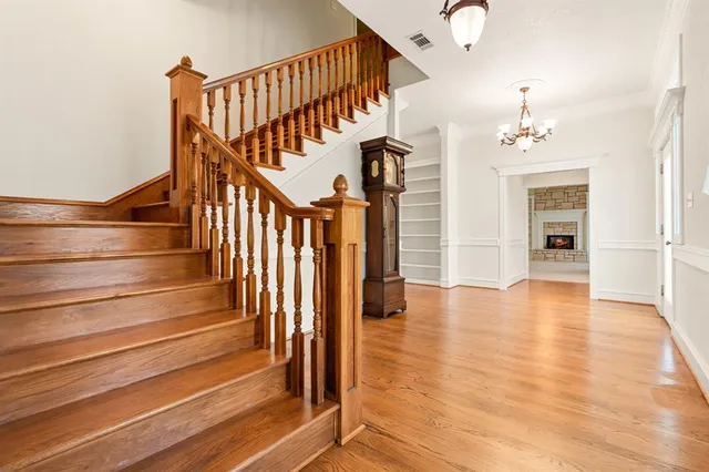 a view of entryway and hall with wooden floor