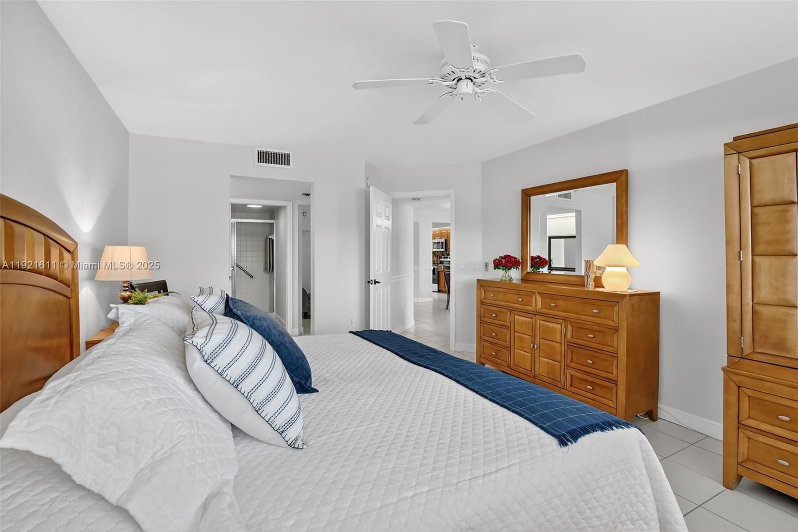 13705 Southwest 12th Street, Unit 103B Pembroke Pines, FL 33027 - Photo 19 of 59 a bedroom with a bed dresser and a window