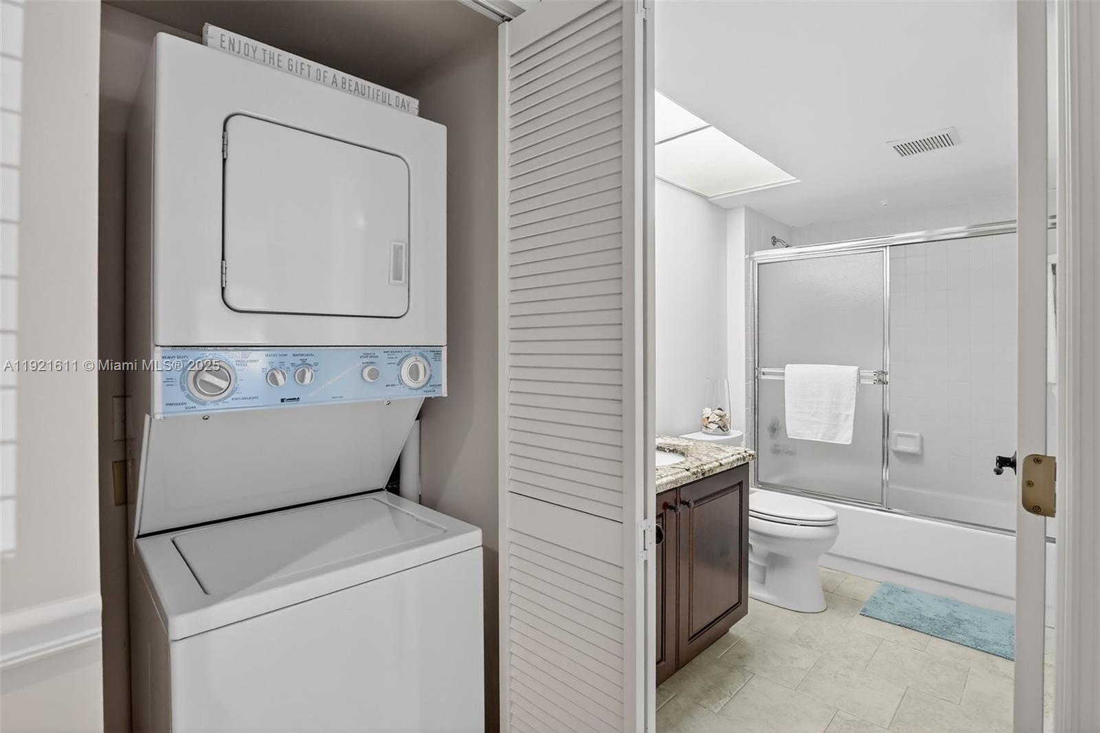 13705 Southwest 12th Street, Unit 103B Pembroke Pines, FL 33027 - Photo 29 of 59 a bathroom with a toilet sink and mirror