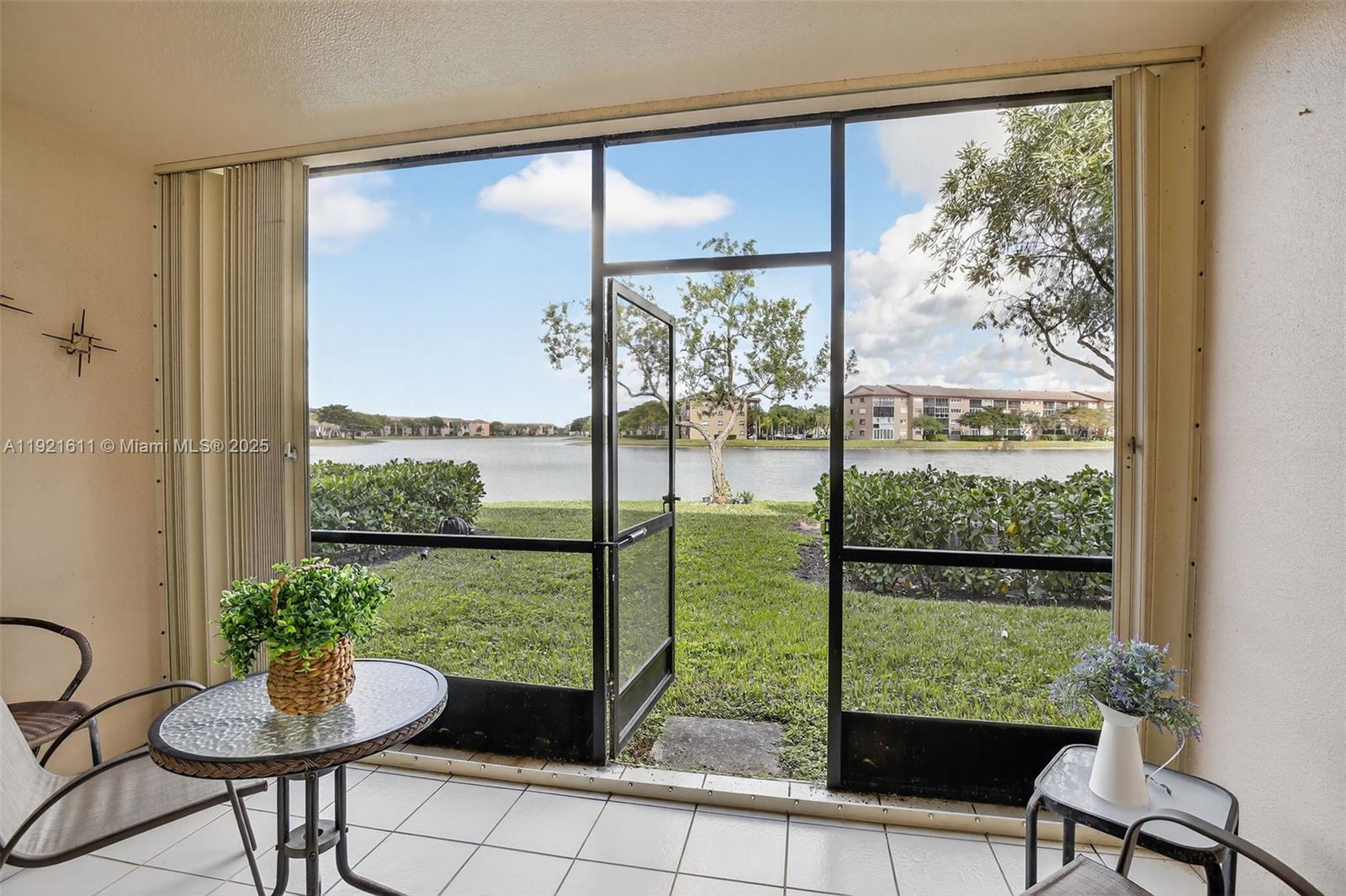 13705 Southwest 12th Street, Unit 103B Pembroke Pines, FL 33027 - Photo 33 of 59 a room with garden view and a potted plant