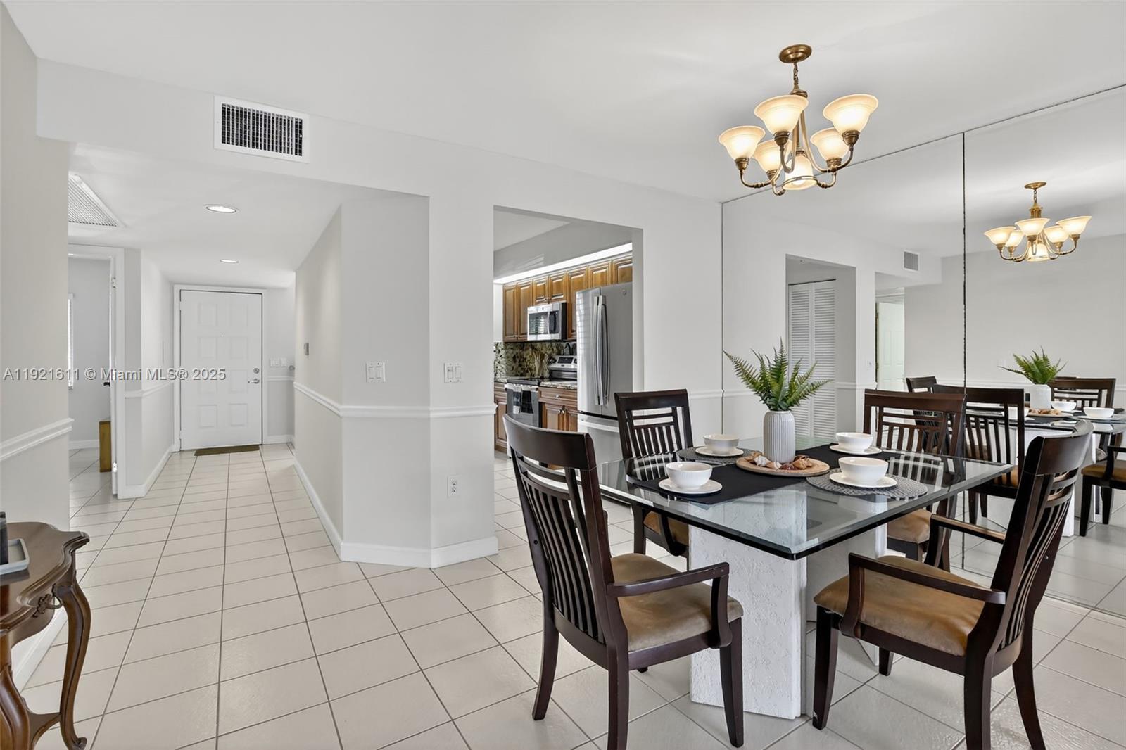 13705 Southwest 12th Street, Unit 103B Pembroke Pines, FL 33027 - Photo 10 of 59 a view of a dining room with furniture and chandelier