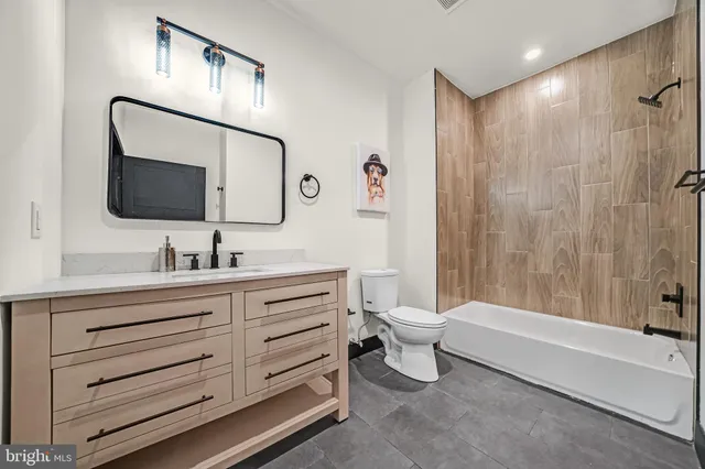 a bathroom with a toilet a sink and bathtub