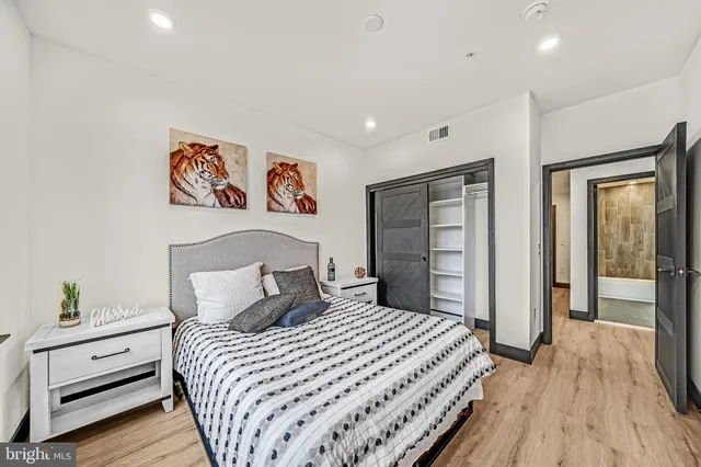 a bedroom with a large bed and a chandelier