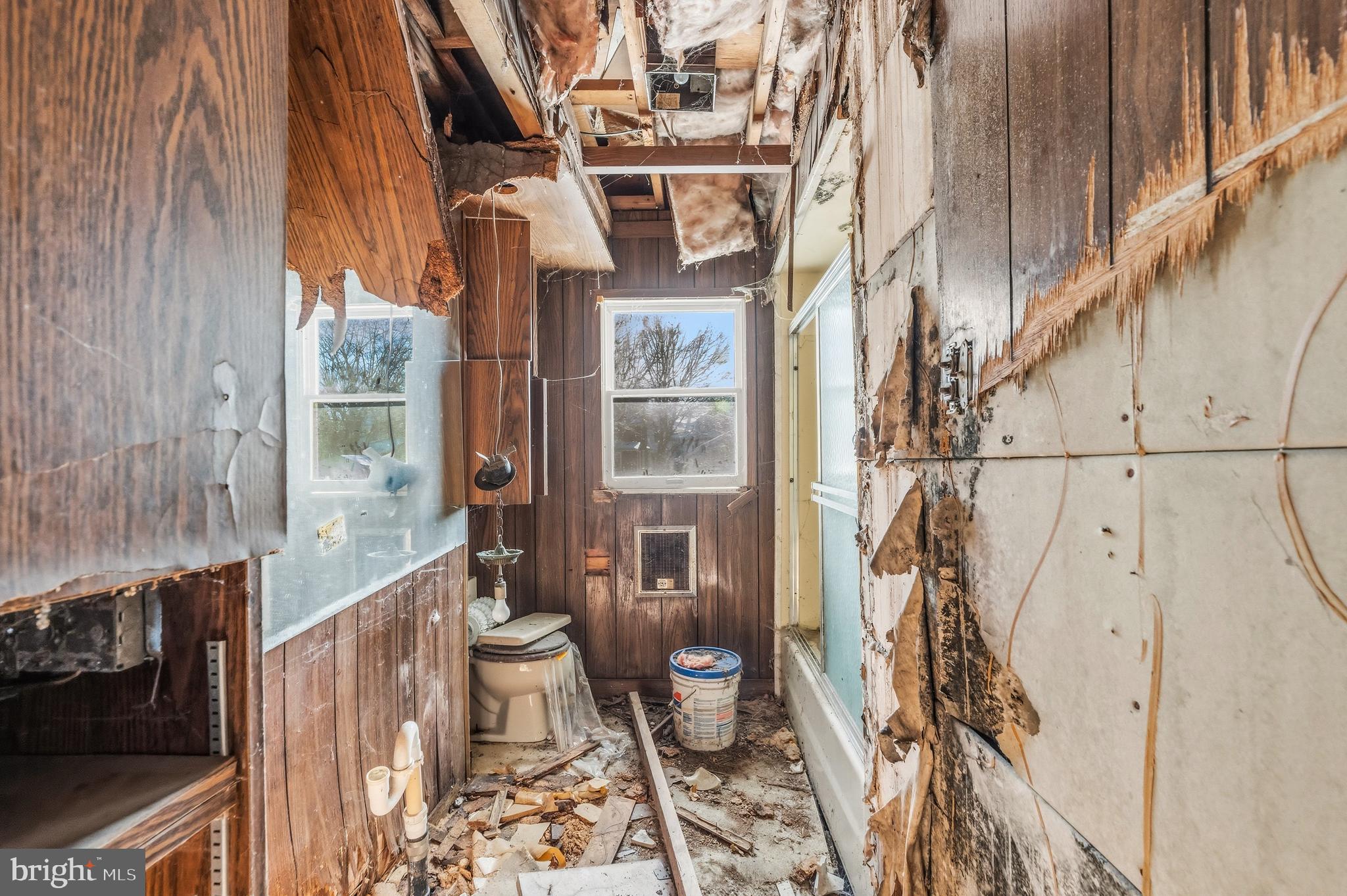 115 8th Street Salem, NJ 08079 - Photo 13 of 20 a bathroom with a toilet and a shower curtain