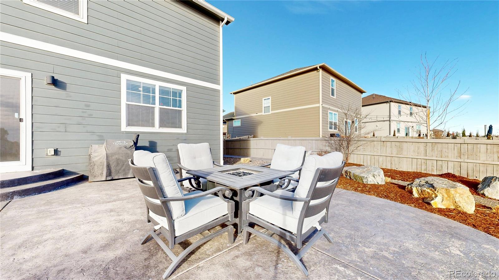 1562 Sun River Road Berthoud, CO 80513 - Photo 29 of 46 a backyard of a house with barbeque oven table and chairs
