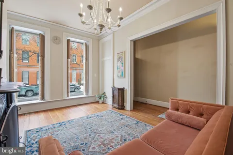 a living room with furniture and a chandelier