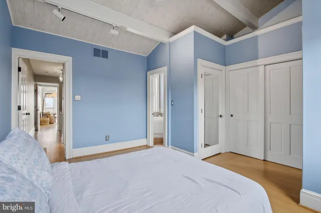 a bedroom with a bed and a bathroom