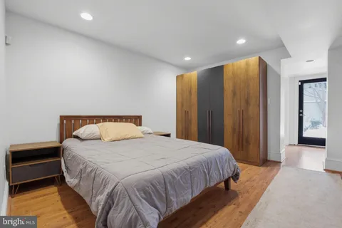 a large bed sitting in a spacious bedroom next to a cabinet