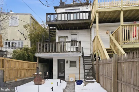 a view of a house with a wooden deck