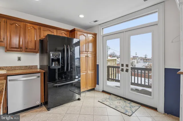 a kitchen with stainless steel appliances granite countertop a refrigerator and a stove