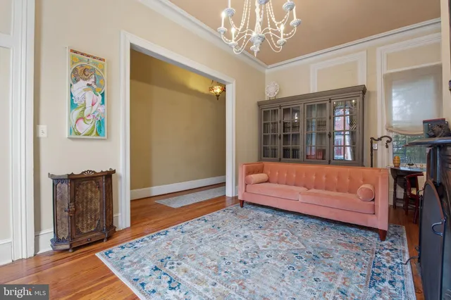 a living room with furniture and a chandelier