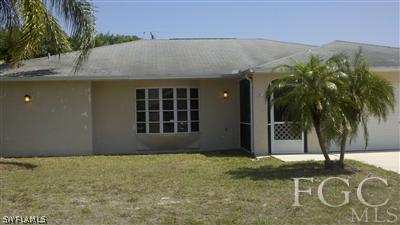 17449 Fuchsia Road Fort Myers, FL 33967 - Photo 1 of 4 a front view of a house with a yard