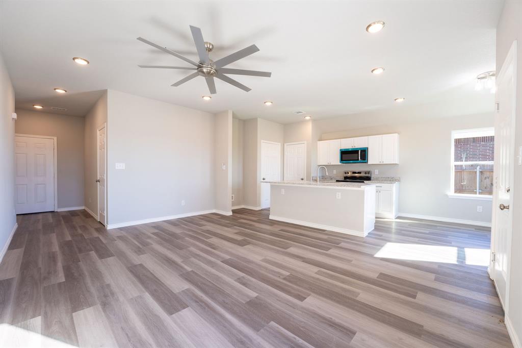 1020 Springview Lane Mabank, TX 75147 - Photo 4 of 15 Unfurnished living room with ceiling fan, light wood-type flooring, and recessed lighting