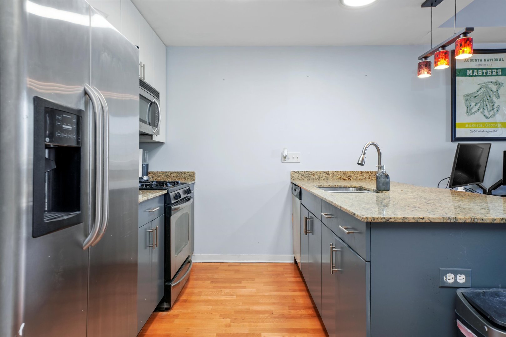 437 West Division Street, Unit 812 Chicago, IL 60610 - Photo 4 of 11 a kitchen with stainless steel appliances granite countertop a sink and refrigerator