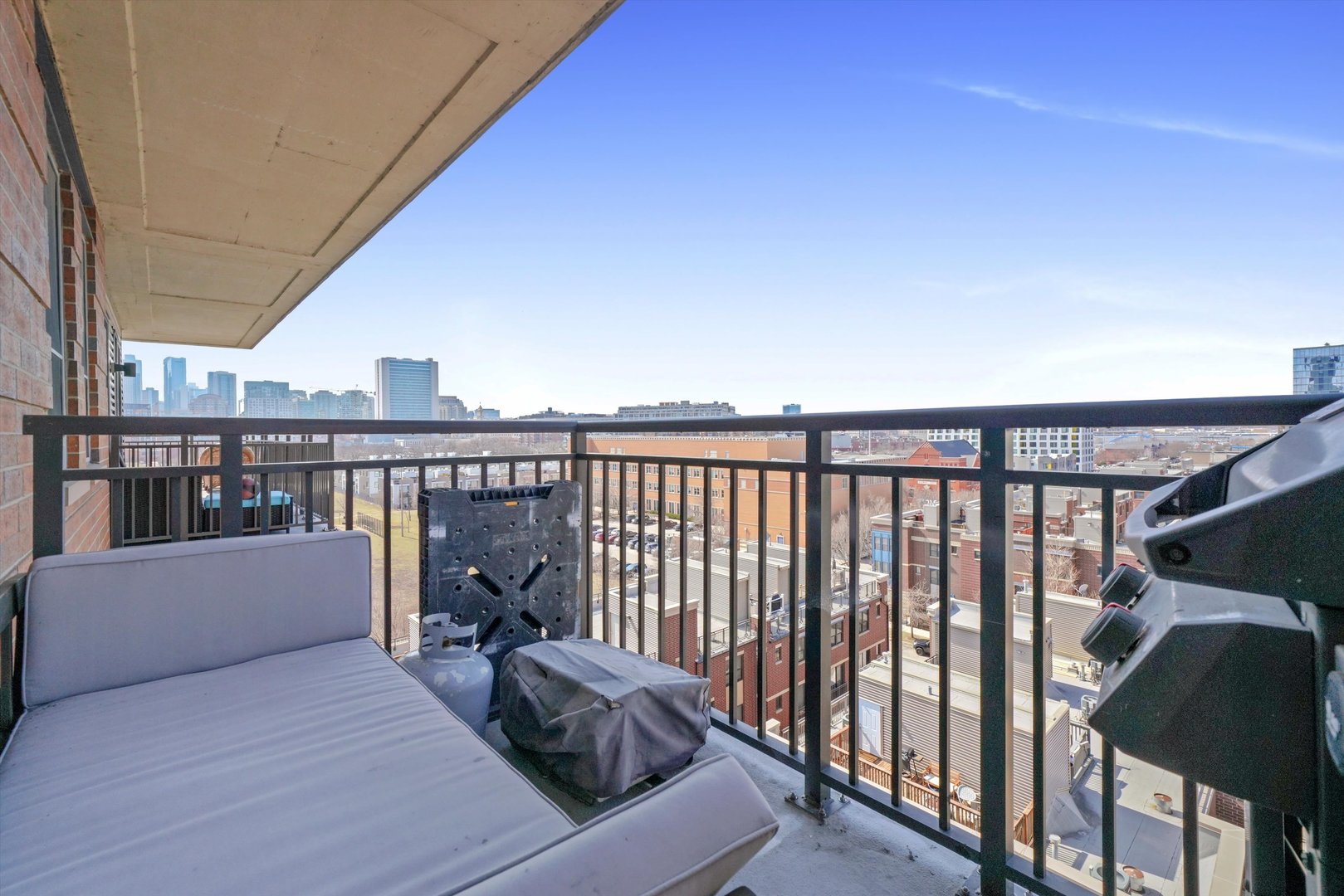 437 West Division Street, Unit 812 Chicago, IL 60610 - Photo 9 of 11 a balcony with furniture and a book shelf
