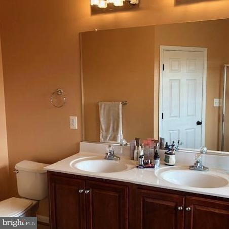 73 Spoon Square Front Royal, VA 22630 - Photo 14 of 28 a bathroom with a granite countertop sink a toilet and a mirror