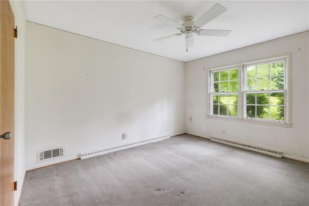 1911 Alderbrook Road Northeast Atlanta, GA 30345 - Photo 17 of 33 an empty room with a window and a ceiling fan