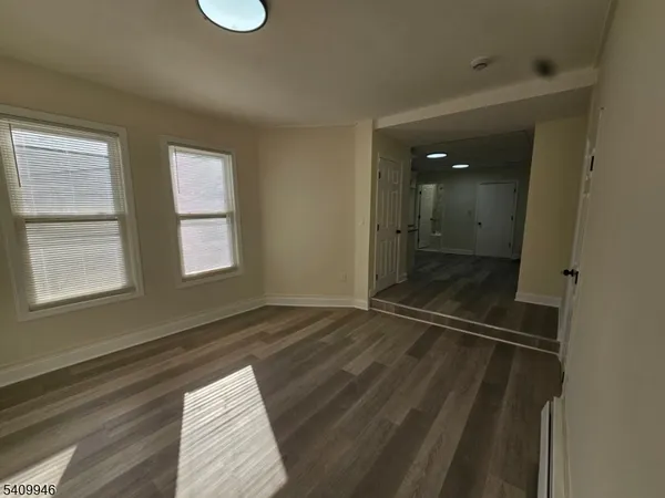 a view of a room that has a bed and a window in it