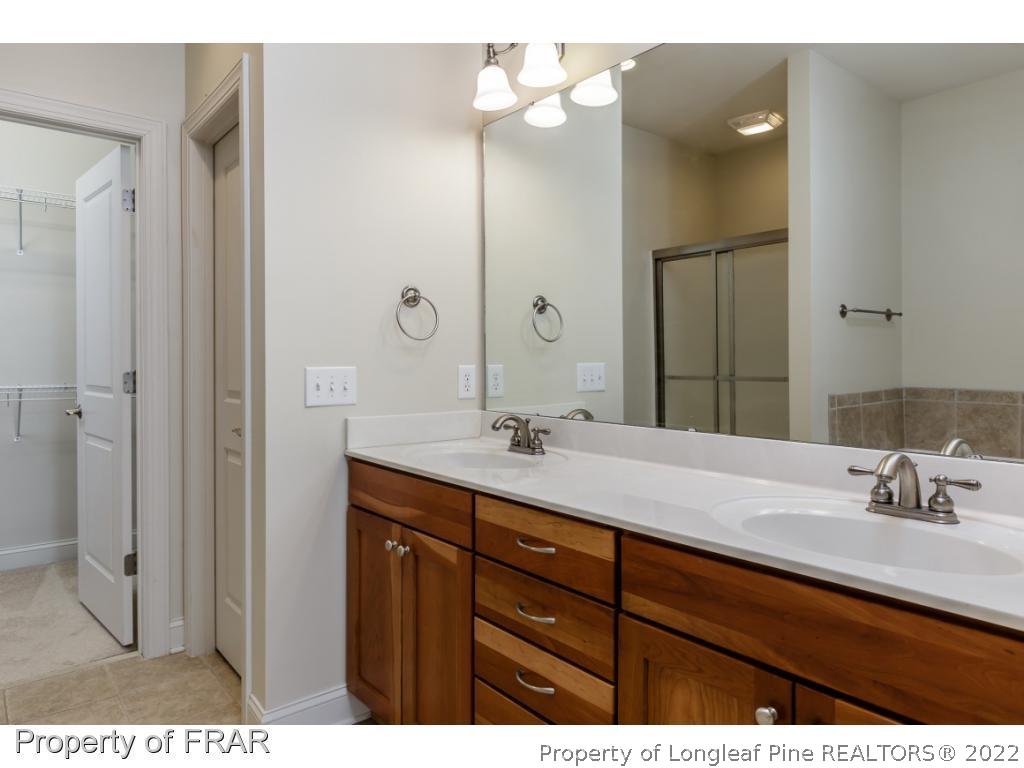 18 Elk Ridge Lane Southern Pines, NC 28387 - Photo 13 of 21 a bathroom with a sink vanity granite and a mirror