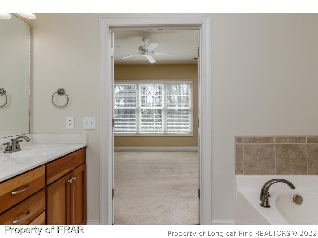18 Elk Ridge Lane Southern Pines, NC 28387 - Photo 14 of 21 a bathroom with a granite countertop sink a mirror and shower