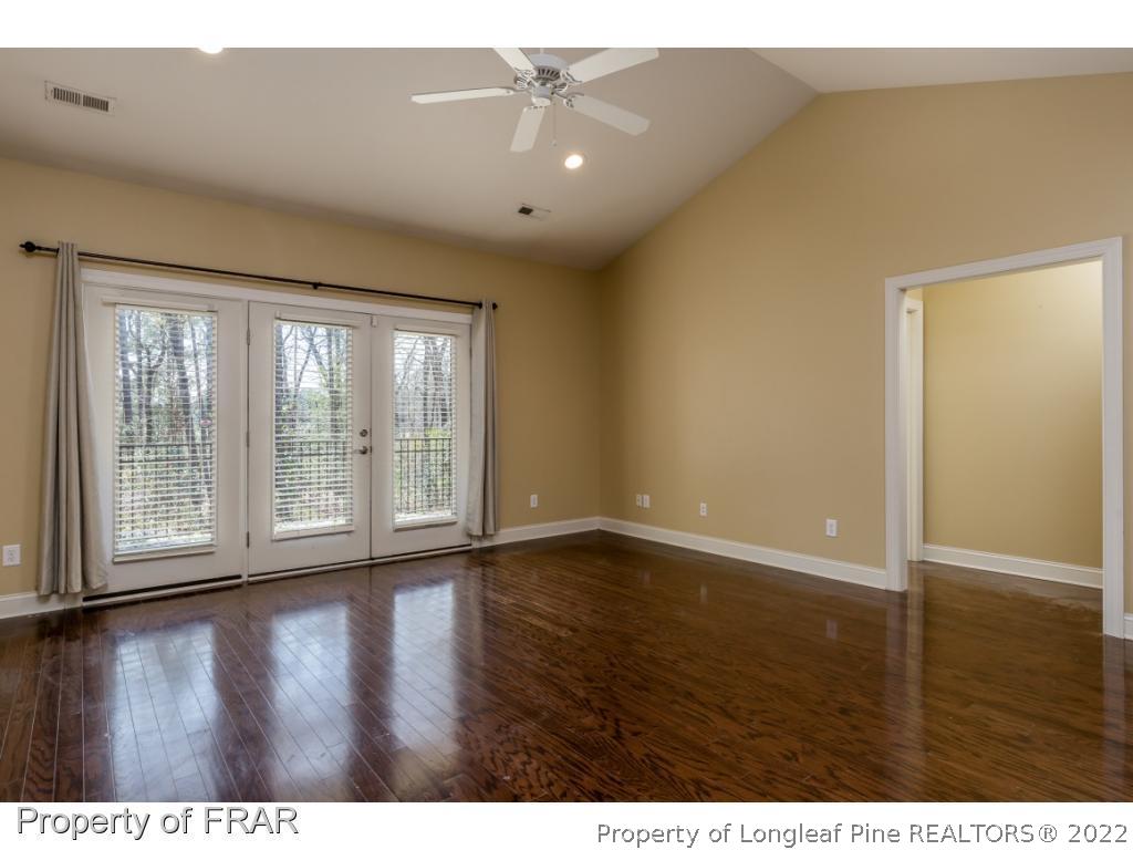 18 Elk Ridge Lane Southern Pines, NC 28387 - Photo 3 of 21 a view of an empty room with wooden floor and a window