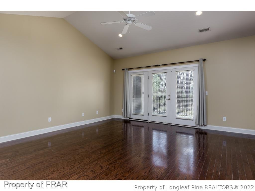 18 Elk Ridge Lane Southern Pines, NC 28387 - Photo 4 of 21 a view of an empty room with wooden floor and a window