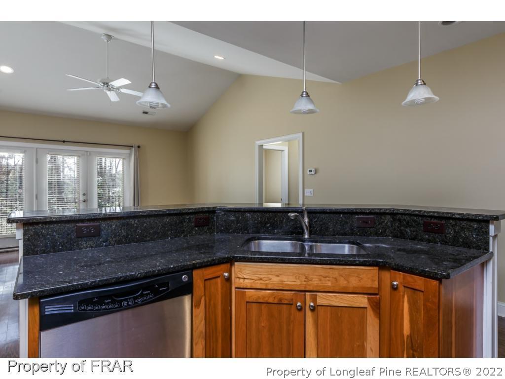 18 Elk Ridge Lane Southern Pines, NC 28387 - Photo 6 of 21 a kitchen with granite countertop a sink and cabinets