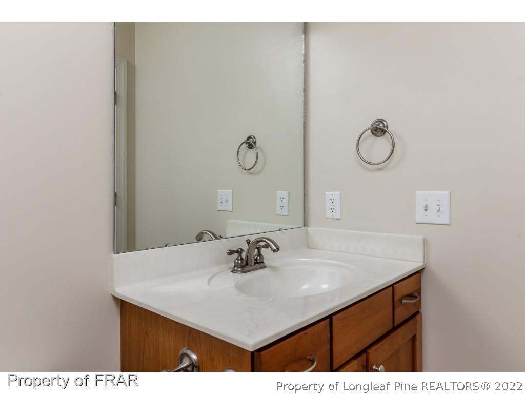 18 Elk Ridge Lane Southern Pines, NC 28387 - Photo 10 of 21 a bathroom with a sink vanity and a mirror