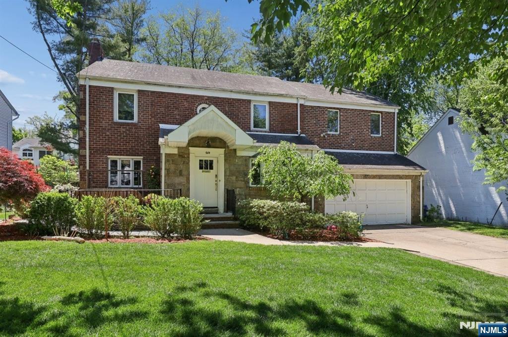 604 Rutland Avenue Teaneck, NJ 07666 - Photo 1 of 31 a front view of a house with a garden and plants