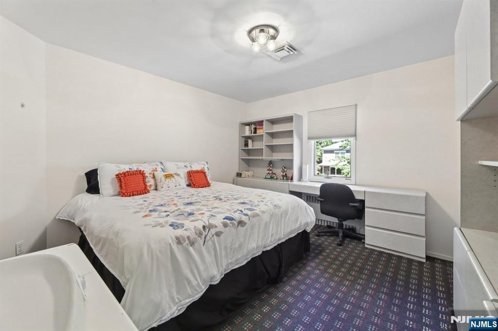 604 Rutland Avenue Teaneck, NJ 07666 - Photo 19 of 31 a bedroom with a bed and a window
