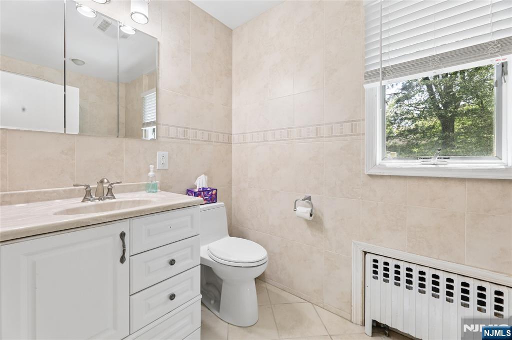 604 Rutland Avenue Teaneck, NJ 07666 - Photo 21 of 31 a bathroom with a sink toilet and vanity