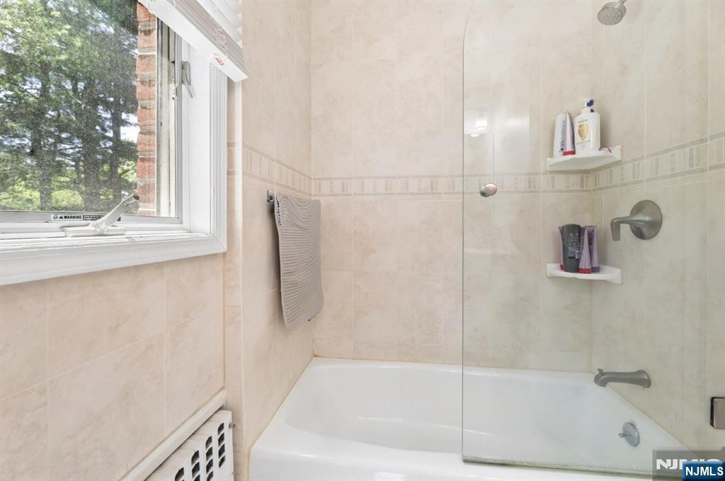 604 Rutland Avenue Teaneck, NJ 07666 - Photo 22 of 31 a bathroom with a bathtub and a shower