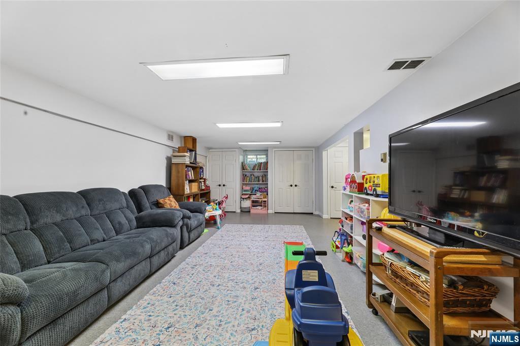 604 Rutland Avenue Teaneck, NJ 07666 - Photo 24 of 31 a living room with furniture and a flat screen tv