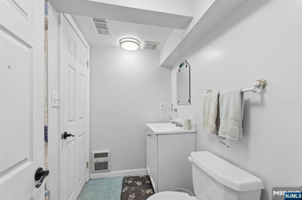 604 Rutland Avenue Teaneck, NJ 07666 - Photo 25 of 31 a bathroom with a toilet sink and shower