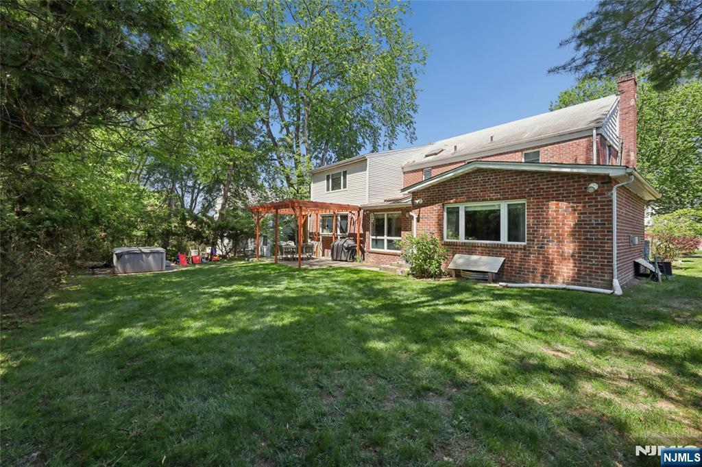 604 Rutland Avenue Teaneck, NJ 07666 - Photo 27 of 31 a view of a house with a backyard porch and sitting area