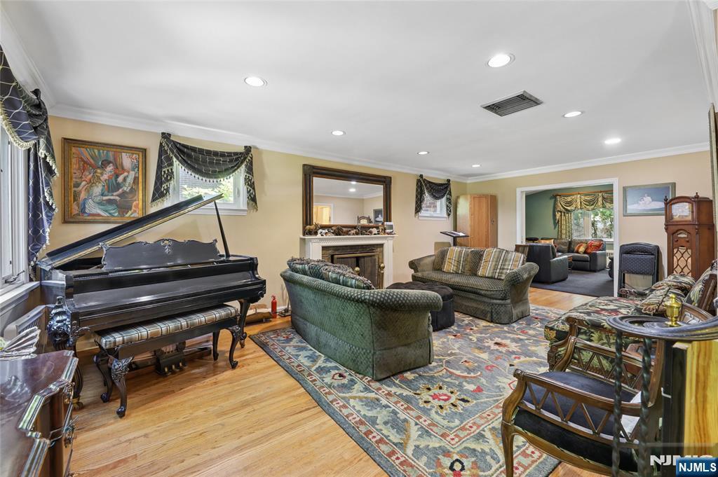 604 Rutland Avenue Teaneck, NJ 07666 - Photo 6 of 31 a living room with furniture and a piano
