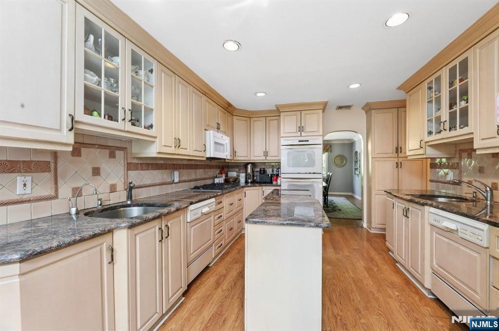604 Rutland Avenue Teaneck, NJ 07666 - Photo 8 of 31 a kitchen with stainless steel appliances granite countertop a sink stove and refrigerator
