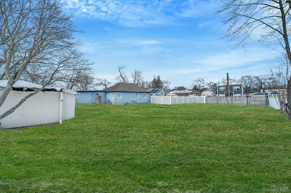 a view of a house with a yard and sitting area