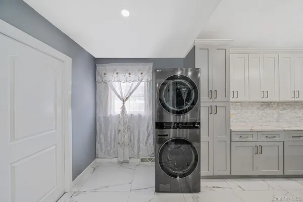 a utility room with sink dryer and washer