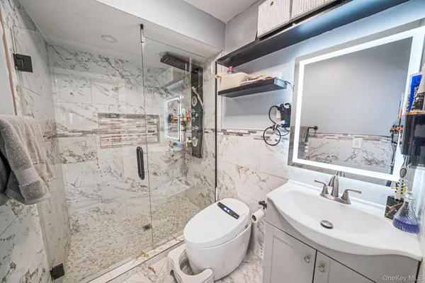 a bathroom with a sink toilet and shower